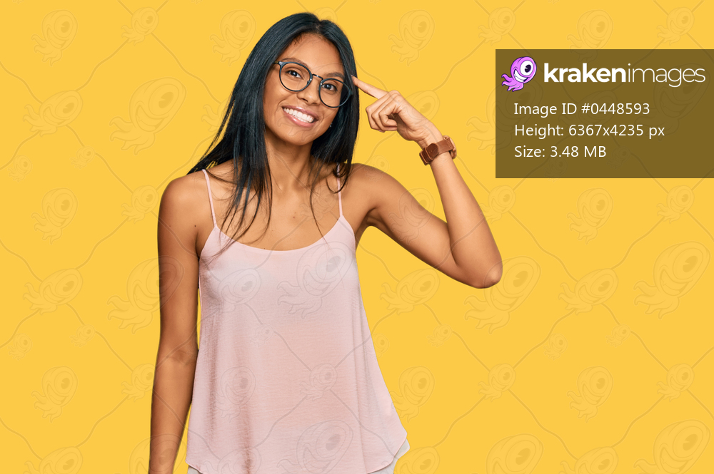 Young african american woman wearing casual clothes and glasses smiling pointing to head with one finger, great idea or thought, good memory 