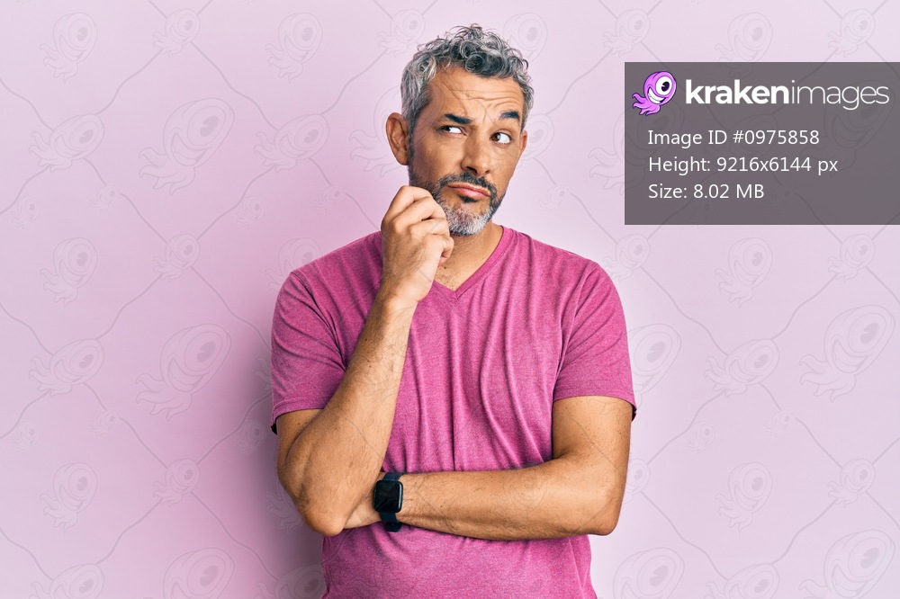 Middle age grey-haired man wearing casual clothes serious face thinking about question with hand on chin, thoughtful about confusing idea 