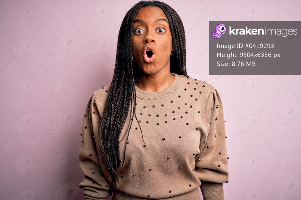 Young african american woman wearing fashion sweater over pink isolated background afraid and shocked with surprise expression, fear and excited face.