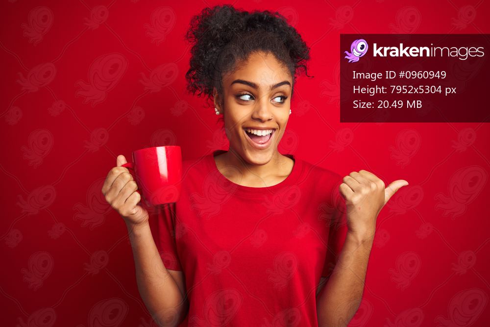 Young african american woman drinking a cup of coffee over isolated red background pointing and showing with thumb up to the side with happy face smiling