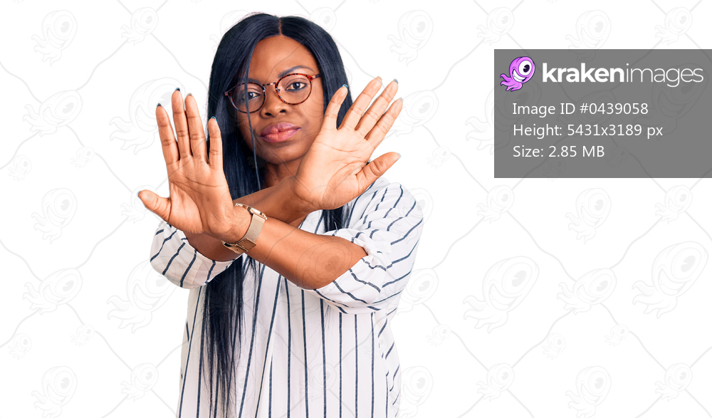 Young african american woman wearing casual clothes and glasses rejection expression crossing arms doing negative sign, angry face 