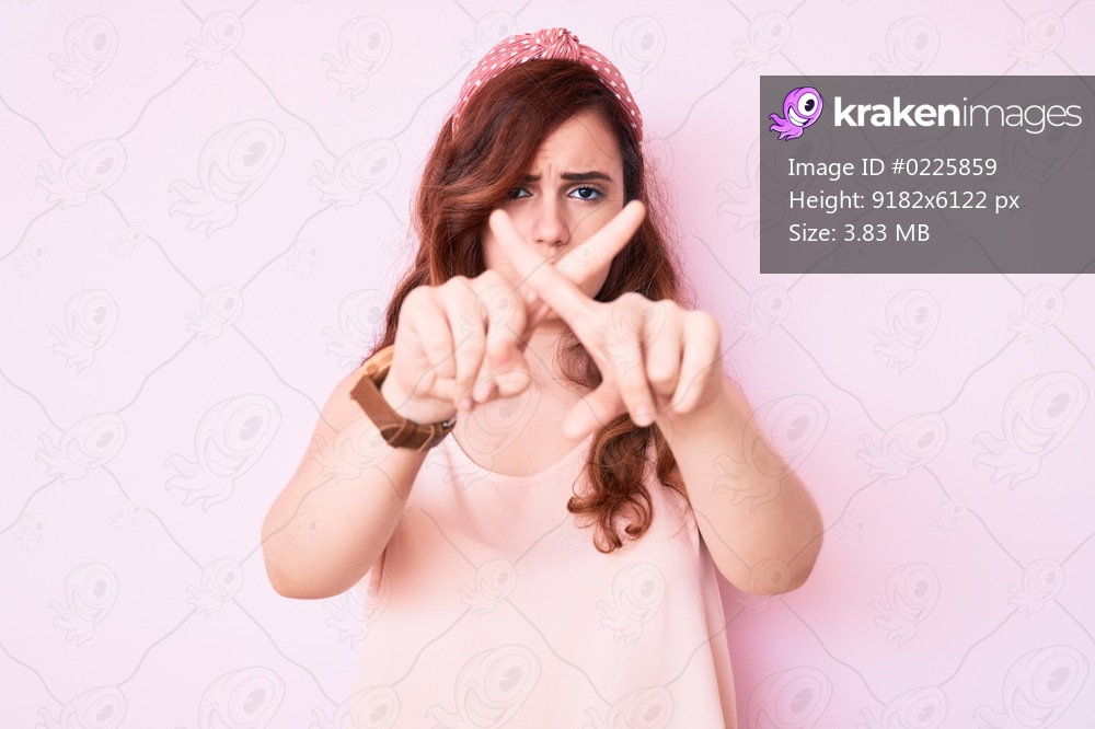 Young beautiful woman wearing casual clothes rejection expression crossing fingers doing negative sign 