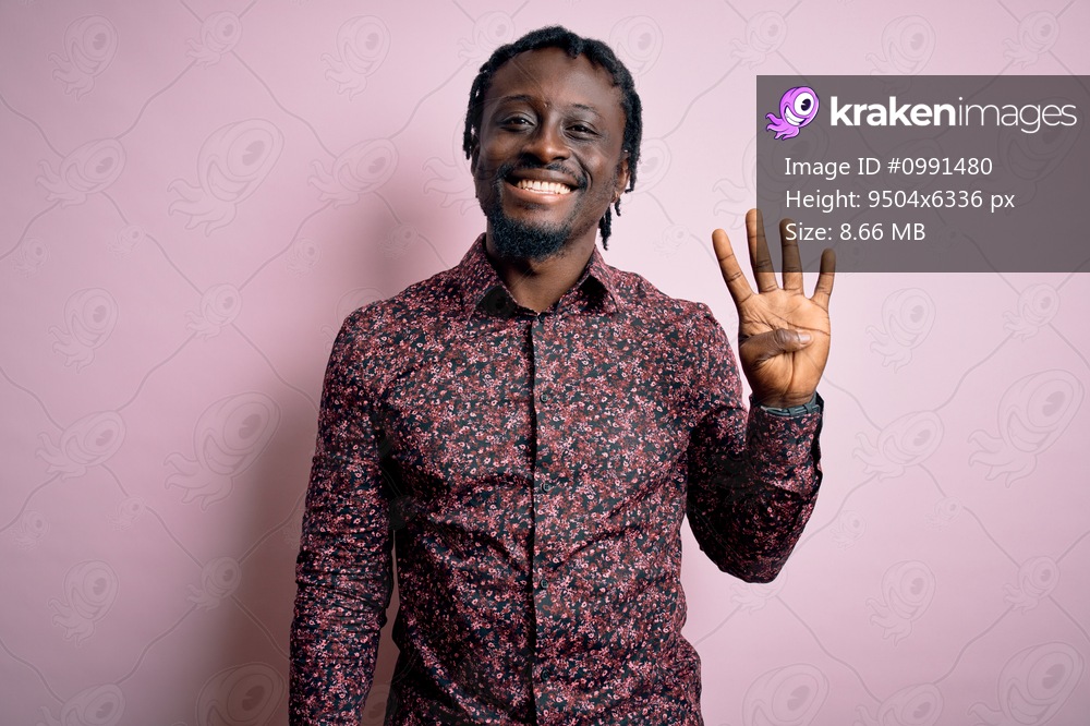 Young handsome african american man wearing casual shirt standing over pink background showing and pointing up with fingers number four while smiling confident and happy.