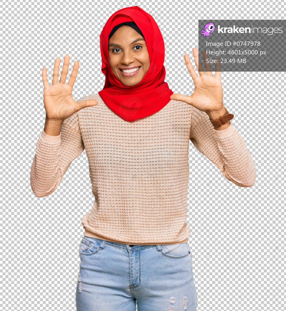 Young african american woman wearing traditional islamic hijab scarf showing and pointing up with fingers number ten while smiling confident and happy.