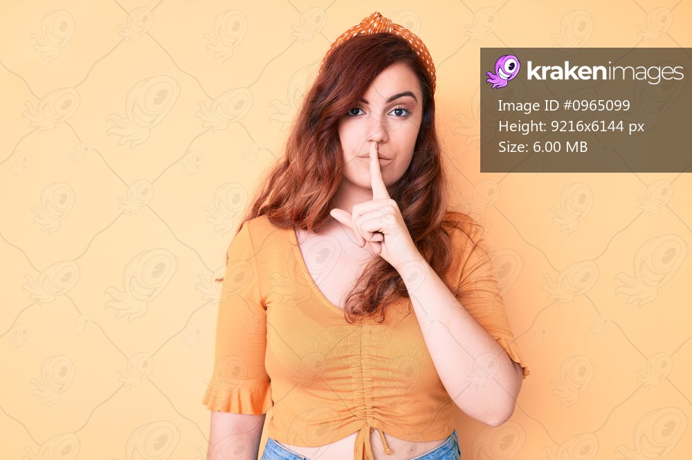 Young beautiful woman wearing casual clothes asking to be quiet with finger on lips. silence and secret concept. 