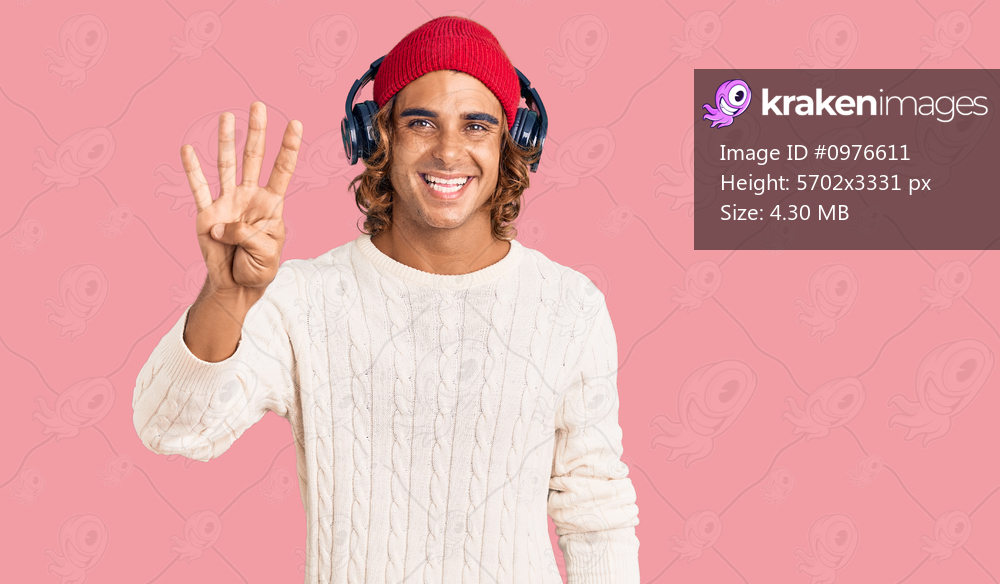 Young hispanic man listening to music using headphones showing and pointing up with fingers number four while smiling confident and happy. 