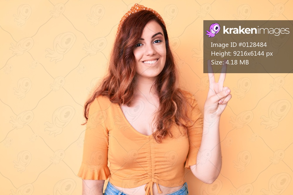 Young beautiful woman wearing casual clothes showing and pointing up with fingers number two while smiling confident and happy. 