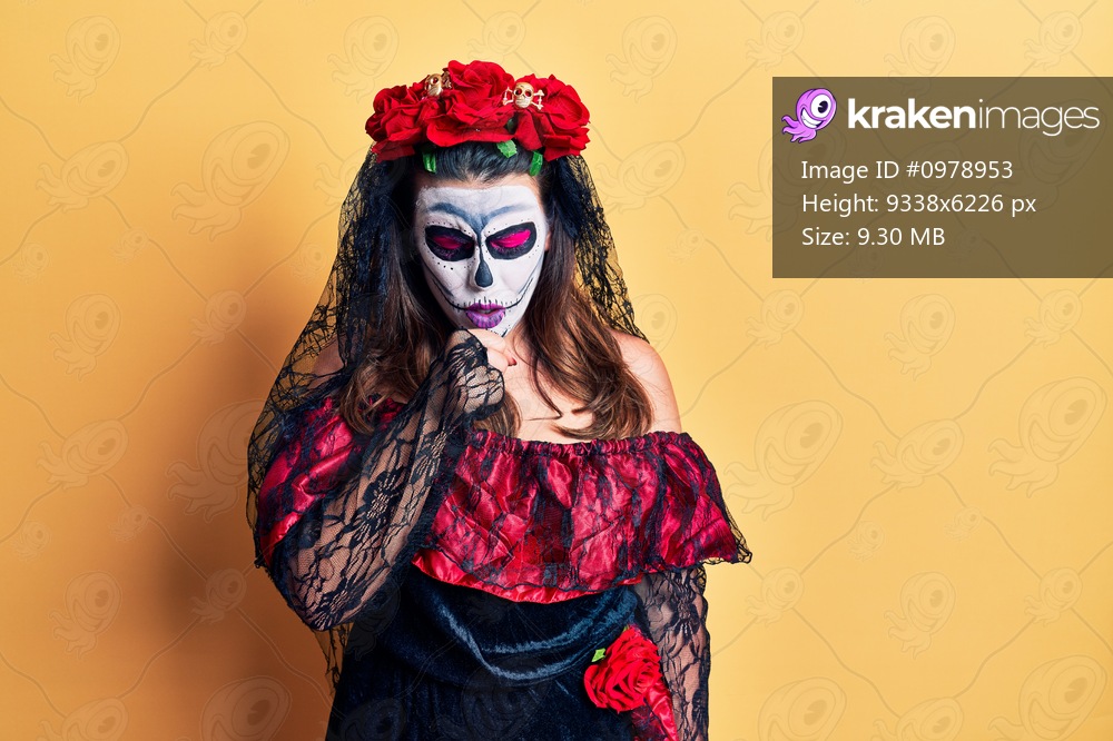 Young woman wearing day of the dead costume over yellow feeling unwell and coughing as symptom for cold or bronchitis. health care concept. 