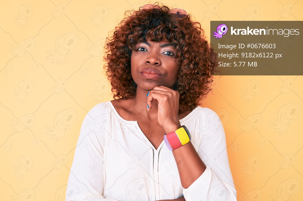 Young african american woman wearing casual clothes serious face thinking about question with hand on chin, thoughtful about confusing idea 