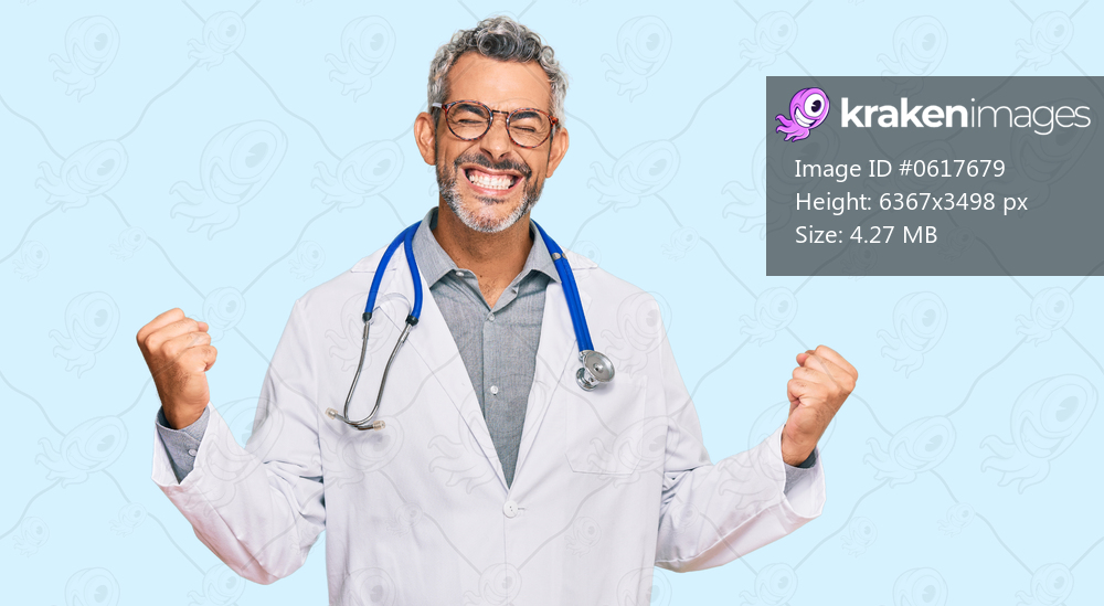 Middle age grey-haired man wearing doctor uniform and stethoscope very happy and excited doing winner gesture with arms raised, smiling and screaming for success. celebration concept. 