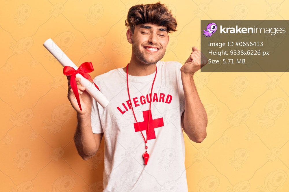 Young hispanic man wearing lifeguard t shirt using binoculars screaming proud, celebrating victory and success very excited with raised arm 