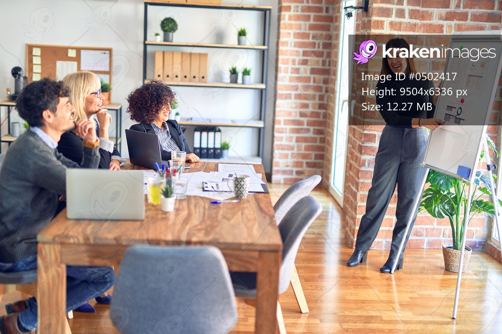 Group of business workers working together in a meeting. One of them making presentation to colleagues at the office
