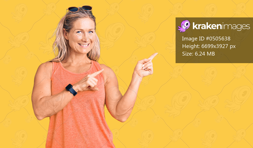 Middle age fit blonde woman wearing casual summer clothes and sunglasses smiling and looking at the camera pointing with two hands and fingers to the side. 