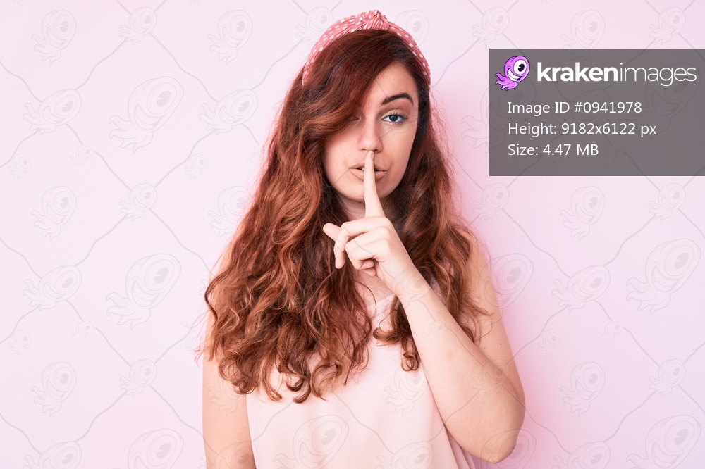 Young beautiful woman wearing casual clothes asking to be quiet with finger on lips. silence and secret concept. 