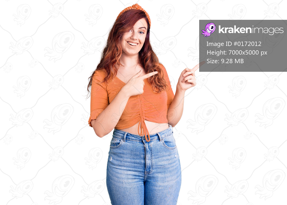 Young beautiful woman wearing casual clothes smiling and looking at the camera pointing with two hands and fingers to the side. 