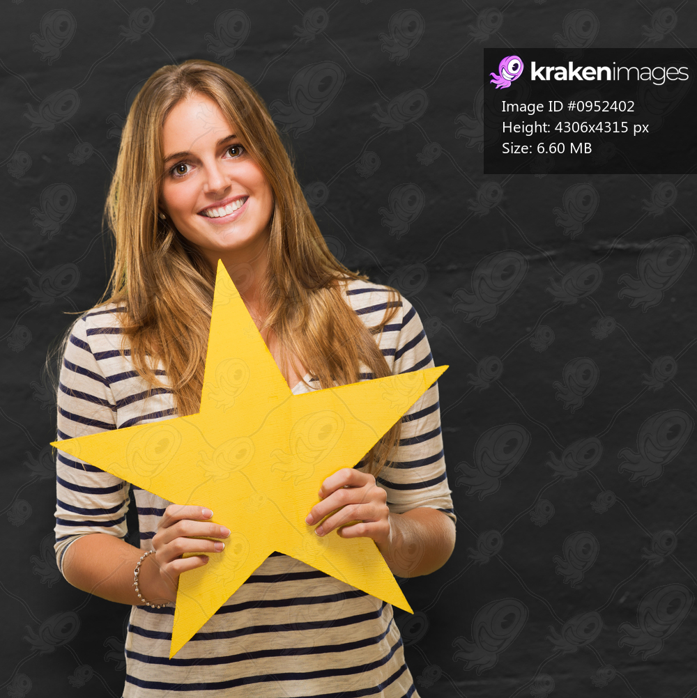 Young Woman Holding Yellow Star against a grunge background