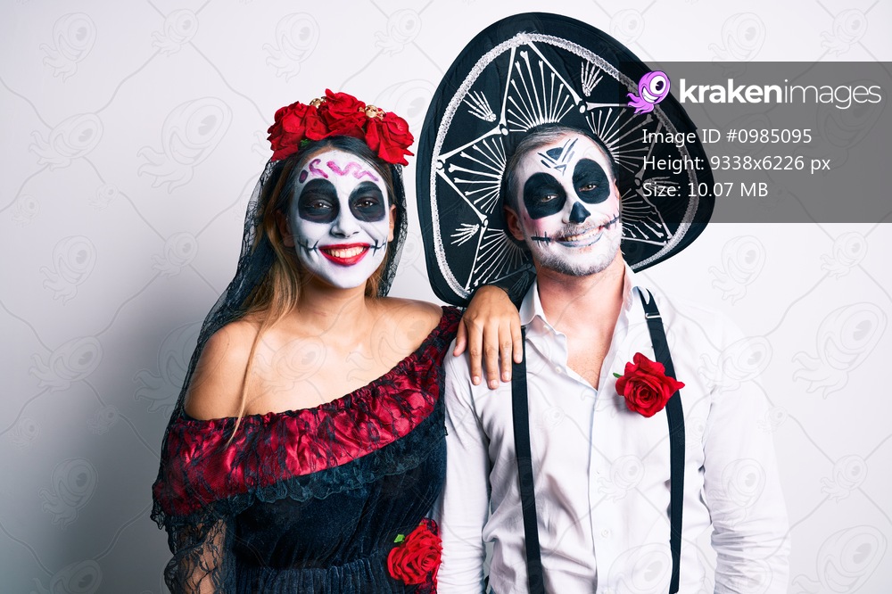 Couple wearing day of the dead costume over white with a happy and cool smile on face. lucky person. 