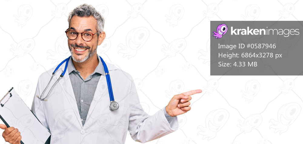 Middle age grey-haired man wearing doctor stethoscope holding clipboard smiling happy pointing with hand and finger to the side 
