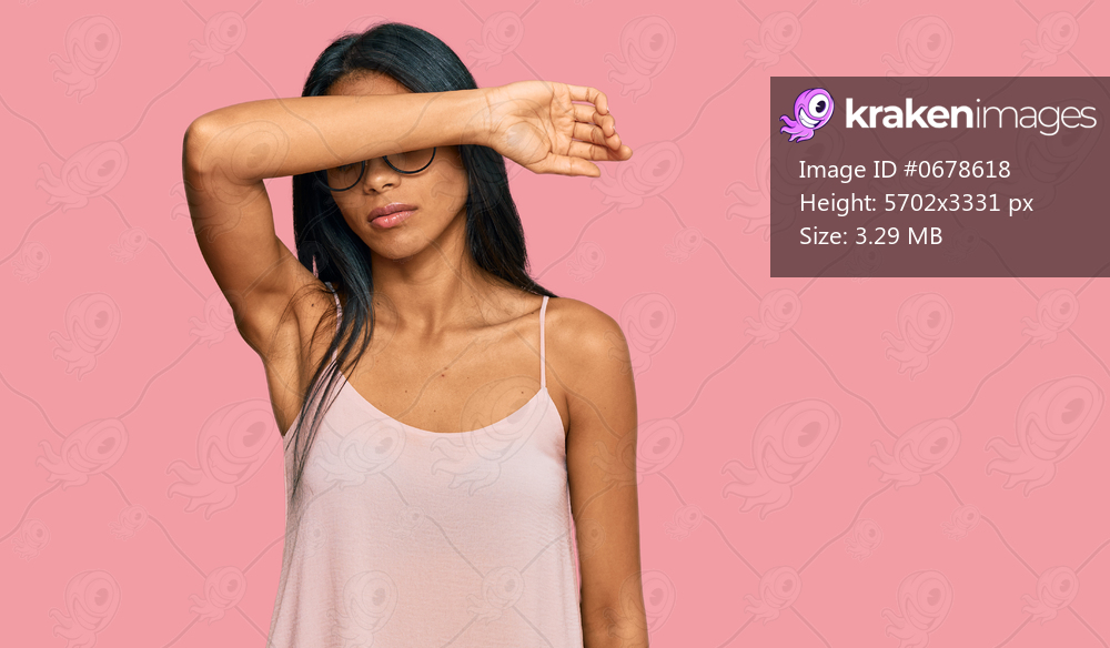 Young african american woman wearing casual clothes and glasses covering eyes with arm, looking serious and sad. sightless, hiding and rejection concept 