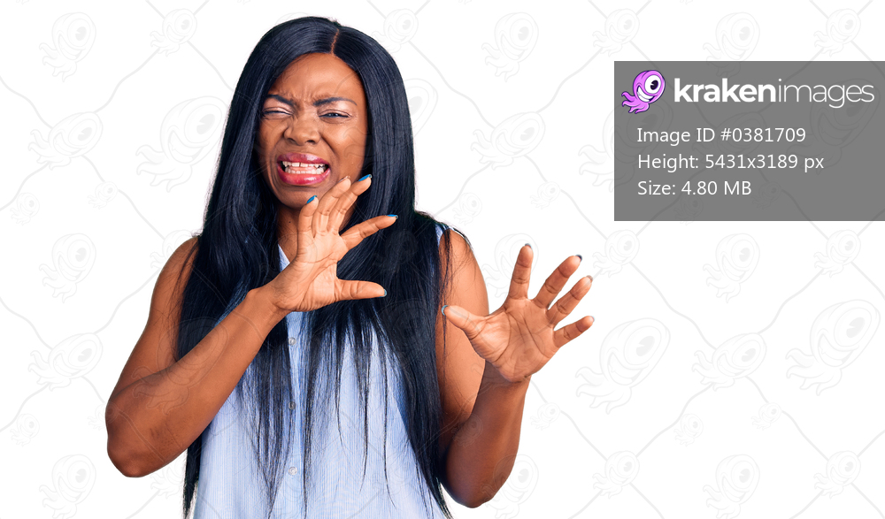 Young african american woman wearing casual clothes disgusted expression, displeased and fearful doing disgust face because aversion reaction. with hands raised 