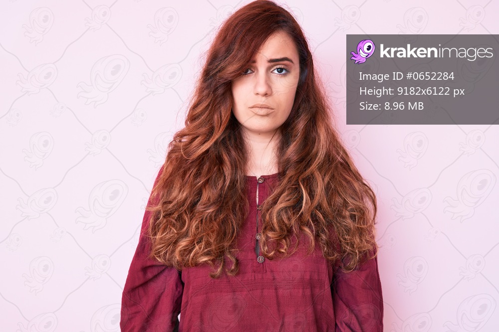 Young beautiful woman wearing casual winter sweater with serious expression on face. simple and natural looking at the camera. 