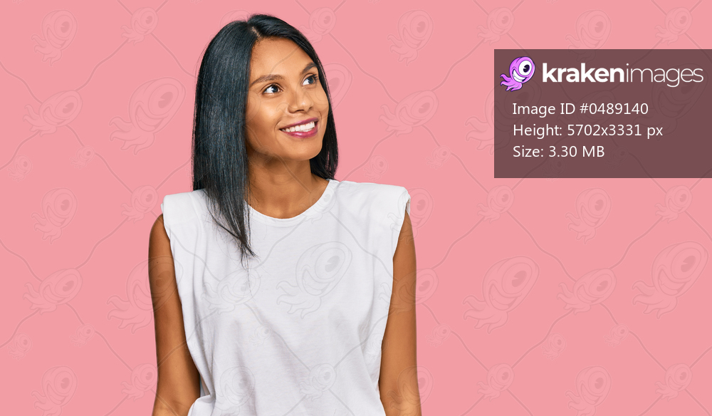 Young african american woman wearing casual clothes looking away to side with smile on face, natural expression. laughing confident. 