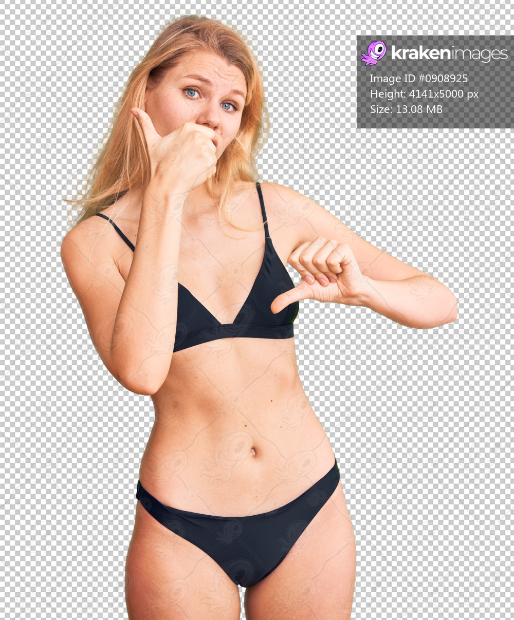 Young beautiful blonde woman wearing bikini doing thumbs up and down, disagreement and agreement expression. crazy conflict