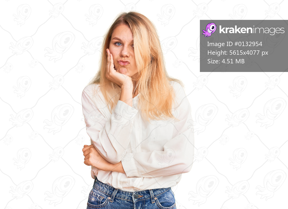 Young beautiful blonde woman wearing casual shirt thinking looking tired and bored with depression problems with crossed arms. 