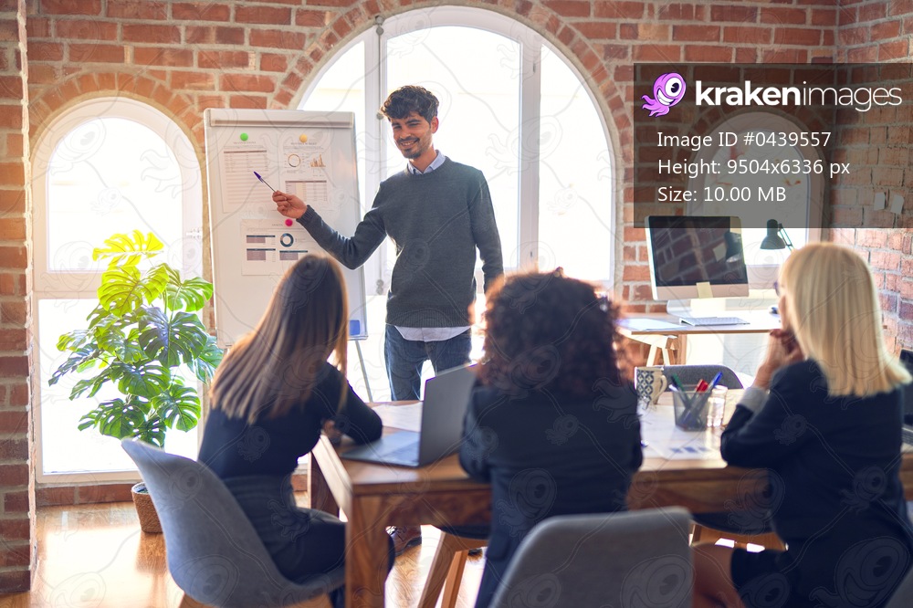 Group of business workers working together in a meeting. One of them making presentation to colleagues at the office