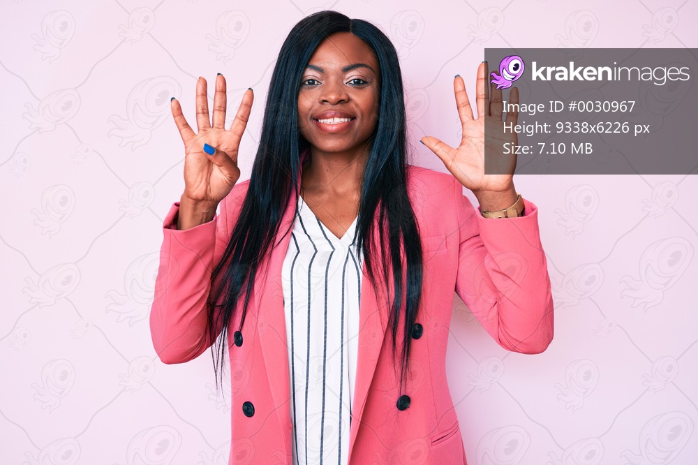 Young african american woman wearing business clothes showing and pointing up with fingers number nine while smiling confident and happy. 