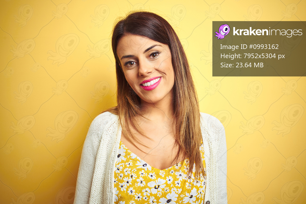 Young beautiful woman wearing jacket standing over yellow isolated background with a happy and cool smile on face. Lucky person.
