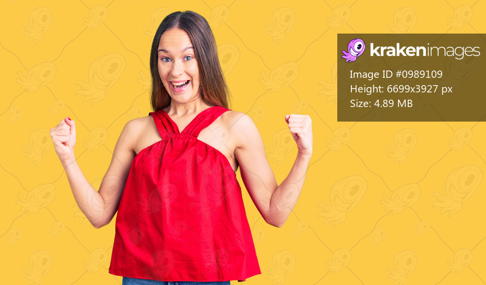 Beautiful brunette young woman wearing casual clothes celebrating surprised and amazed for success with arms raised and open eyes. winner concept. 