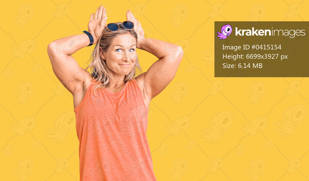 Middle age fit blonde woman wearing casual summer clothes and sunglasses doing bunny ears gesture with hands palms looking cynical and skeptical. easter rabbit concept. 