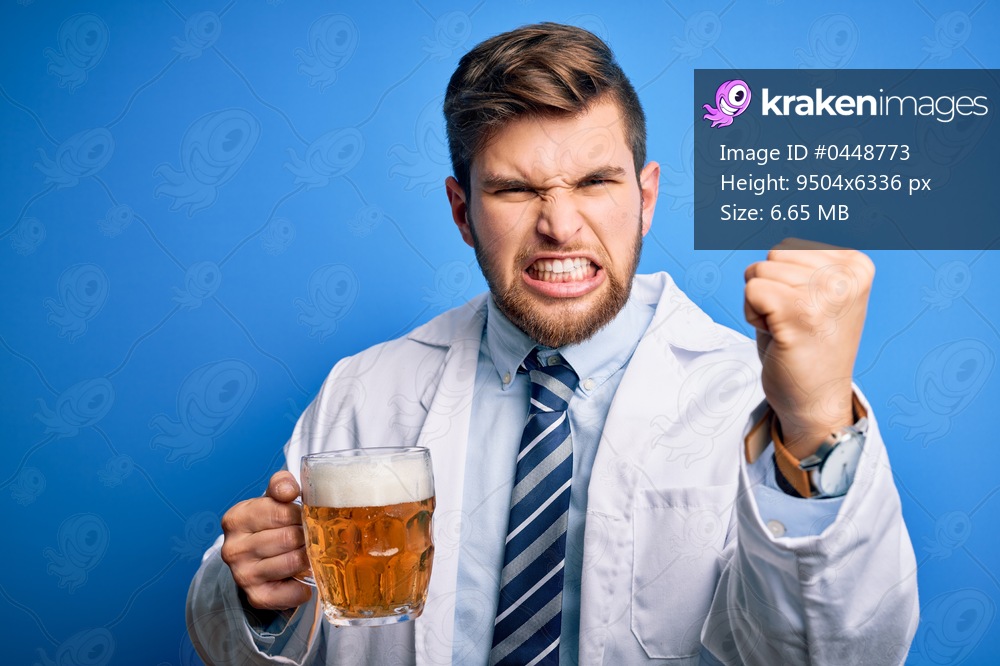 Young blond doctor man with beard and blue eyes wearing coat drinking jar of beer annoyed and frustrated shouting with anger, crazy and yelling with raised hand, anger concept