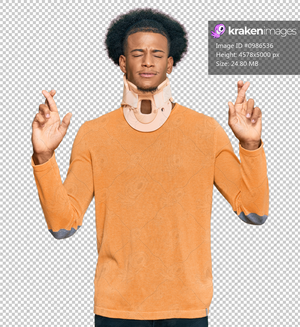 African american man with afro hair wearing cervical neck collar gesturing finger crossed smiling with hope and eyes closed. luck and superstitious concept.
