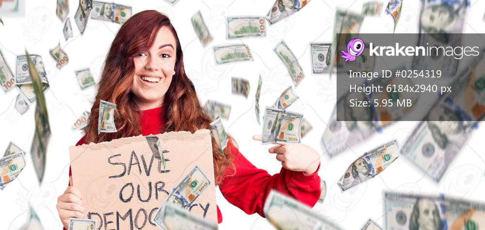 Young beautiful woman holding save our democracy protest banner smiling happy pointing with hand and finger
