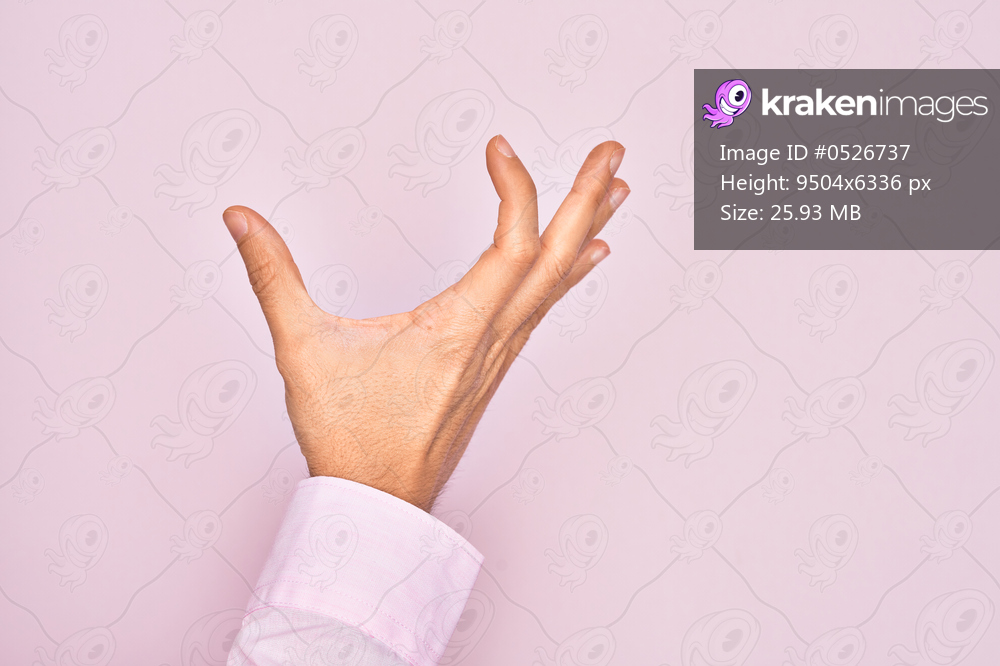 Hand of caucasian young man showing fingers over isolated pink background picking and taking invisible thing, holding object with fingers showing space