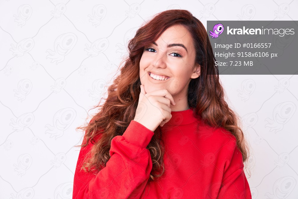 Young beautiful woman wearing casual clothes looking confident at the camera smiling with crossed arms and hand raised on chin. thinking positive. 