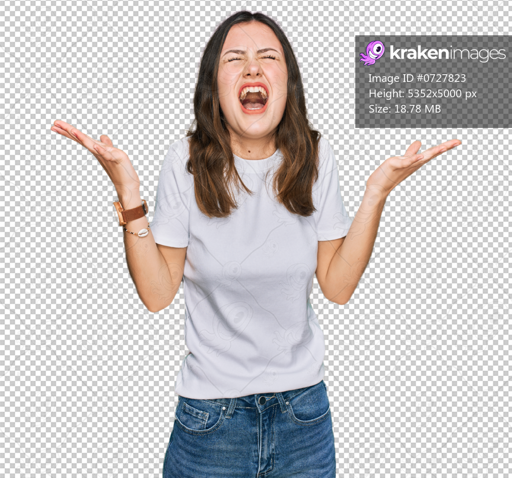 Young beautiful woman wearing casual white t shirt celebrating mad and crazy for success with arms raised and closed eyes screaming excited. winner concept