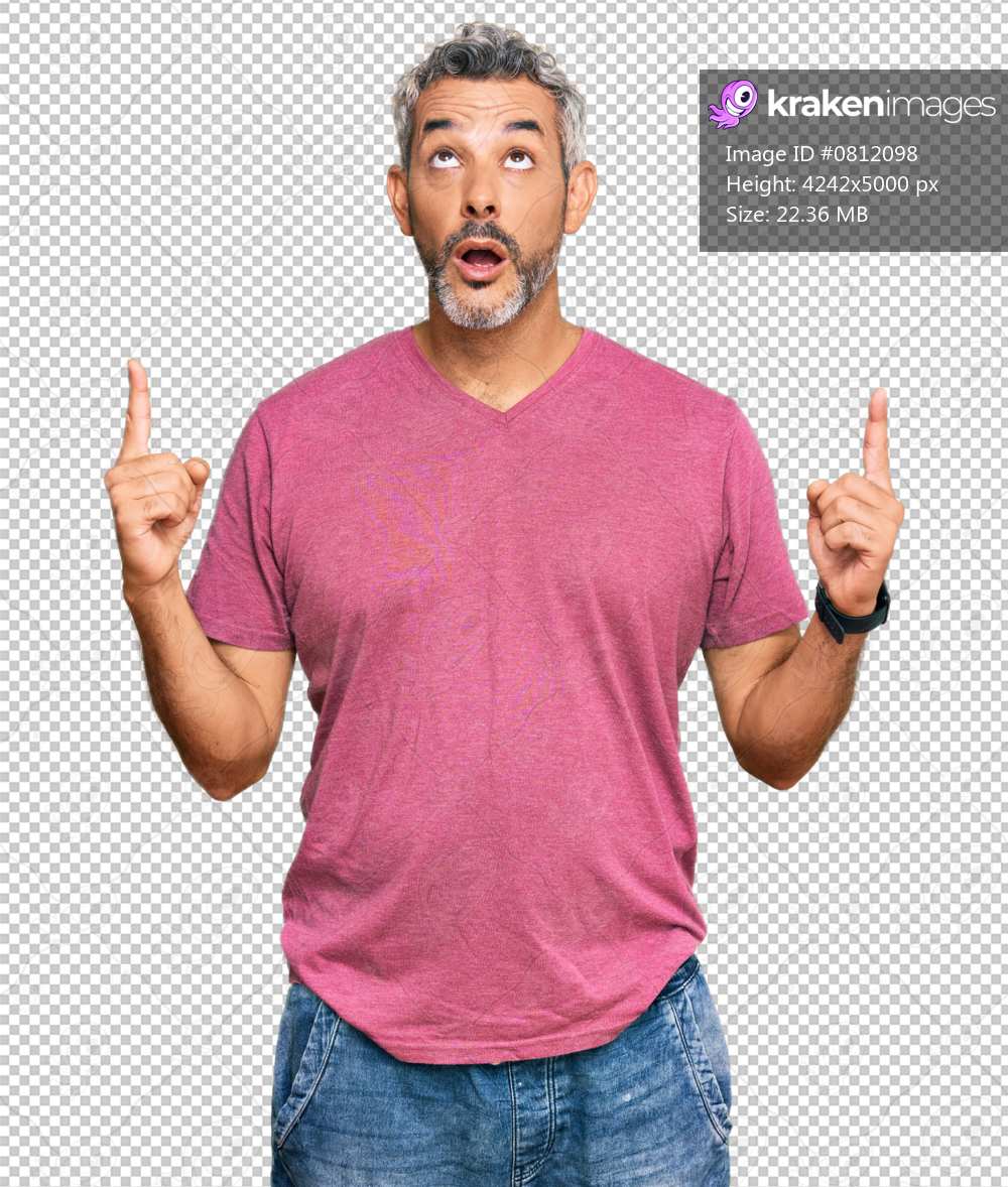 Middle age grey-haired man wearing casual clothes amazed and surprised looking up and pointing with fingers and raised arms.
