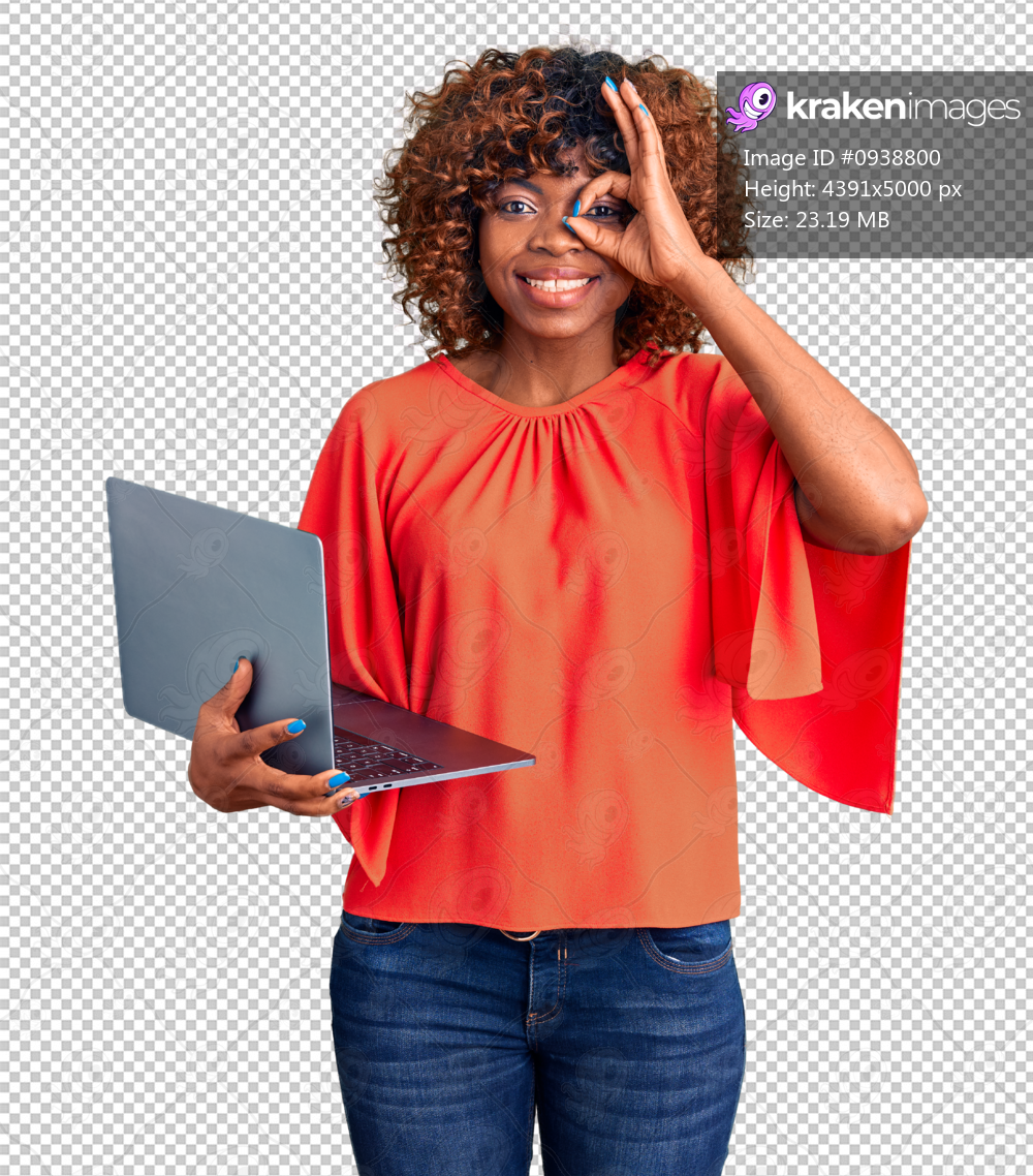 Young african american woman working using computer laptop smiling happy doing ok sign with hand on eye looking through fingers
