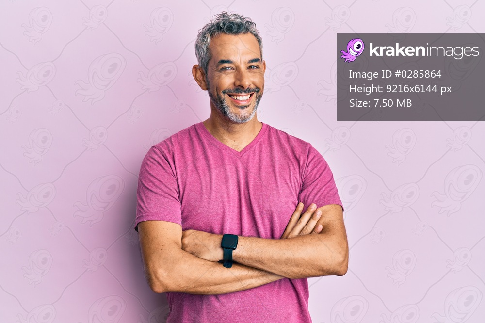 Middle age grey-haired man wearing casual clothes happy face smiling with crossed arms looking at the camera. positive person. 
