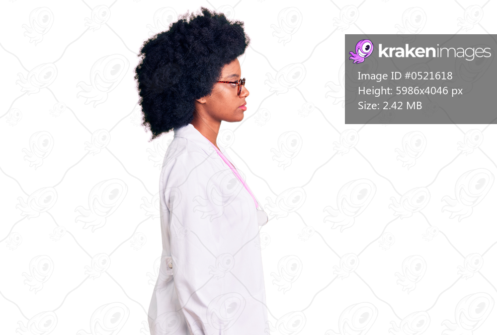 Young african american woman wearing doctor coat and stethoscope looking to side, relax profile pose with natural face and confident smile. 