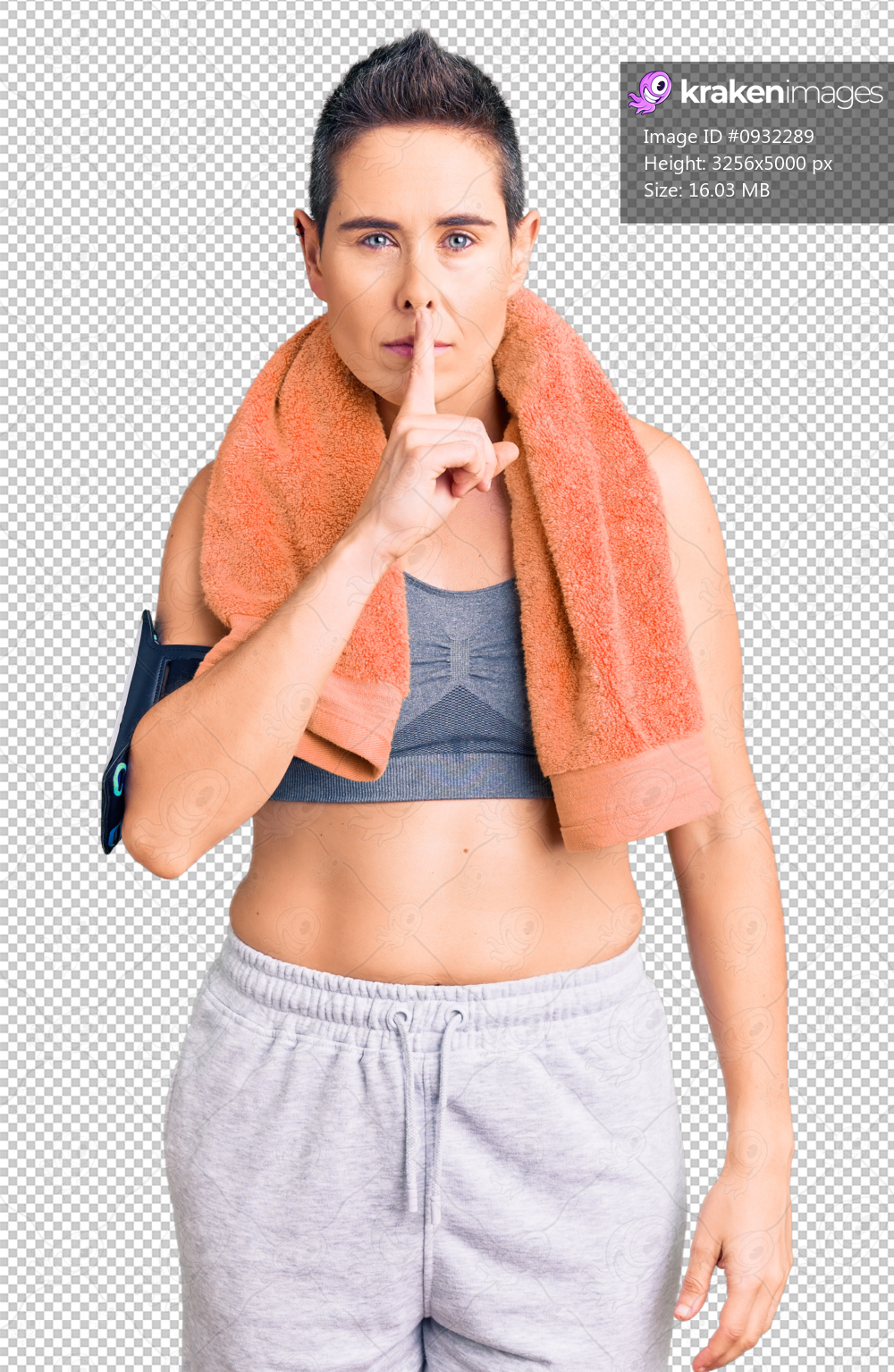 Young woman with short hair wearing sportswear and towel using smartphone asking to be quiet with finger on lips. silence and secret concept.