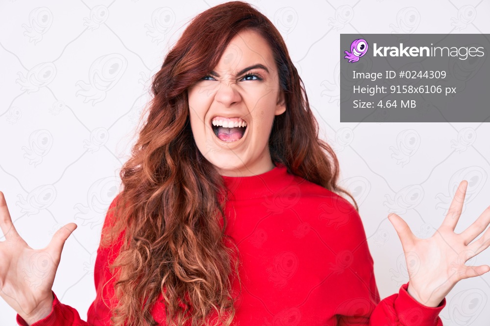 Young beautiful woman wearing casual clothes crazy and mad shouting and yelling with aggressive expression and arms raised. frustration concept. 
