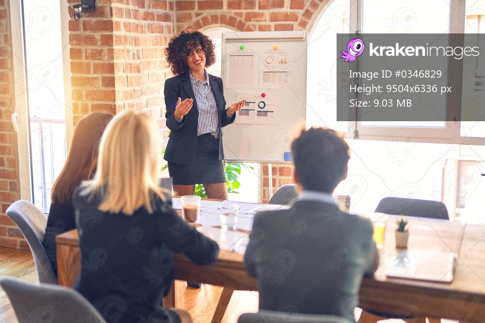 Group of business workers working together in a meeting. One of them making presentation to colleagues at the office