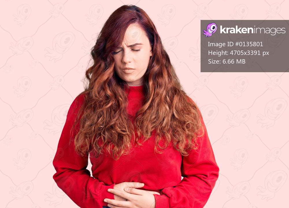 Young beautiful woman wearing casual winter sweater with hand on stomach because indigestion, painful illness feeling unwell. ache concept. 