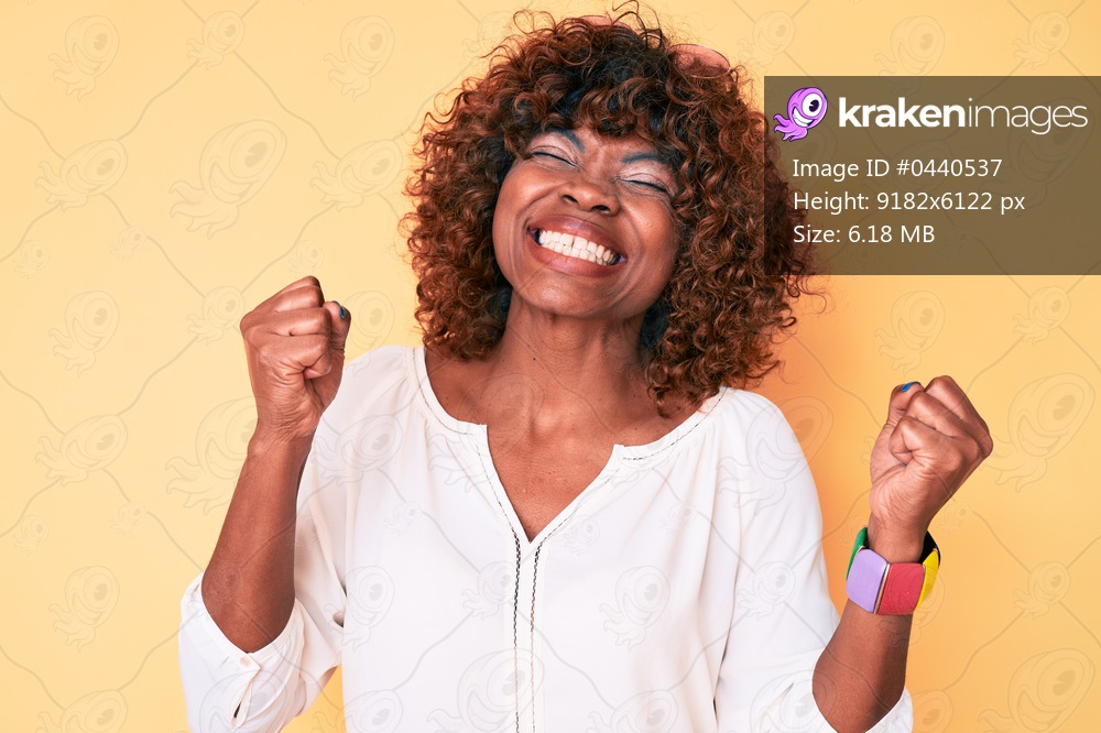 Young african american woman wearing casual clothes very happy and excited doing winner gesture with arms raised, smiling and screaming for success. celebration concept. 