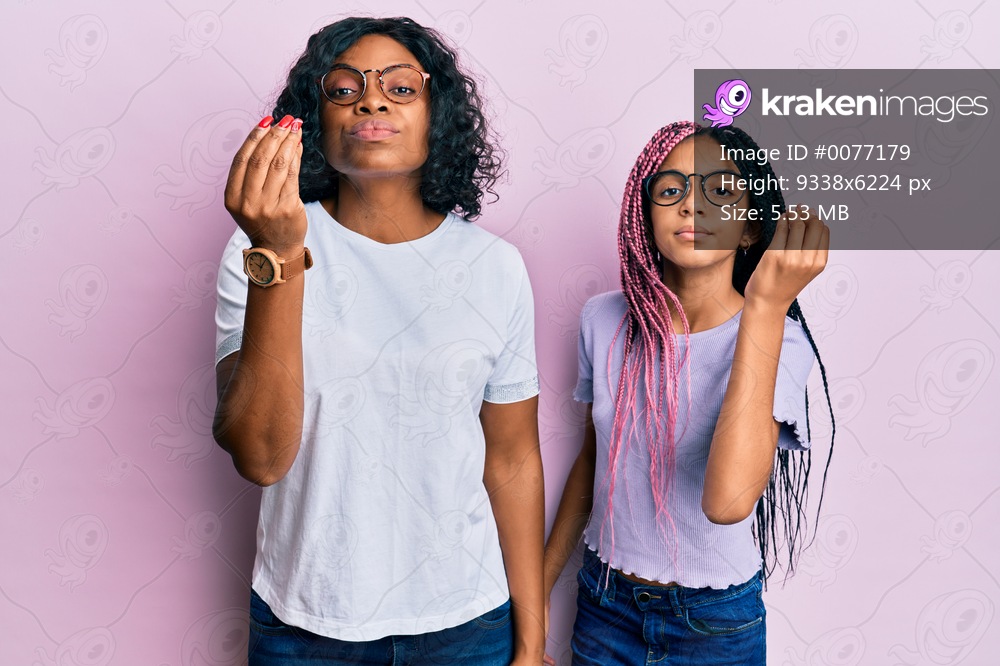 Beautiful african american mother and daughter wearing casual clothes and glasses doing italian gesture with hand and fingers confident expression 