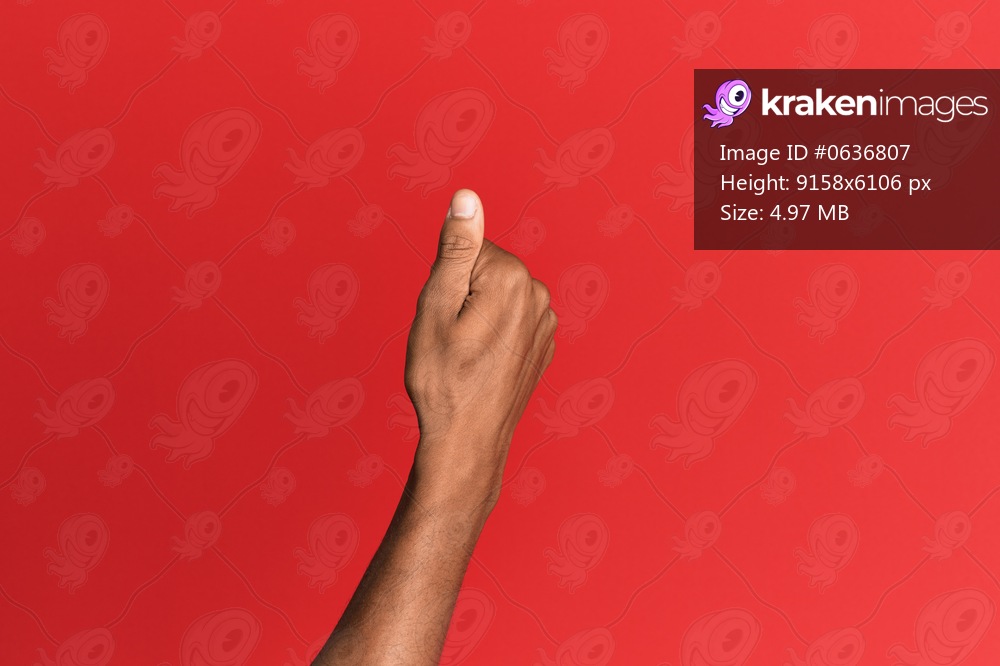 Hand of hispanic man over red isolated background holding blank space with thumb finger, business and advertising 